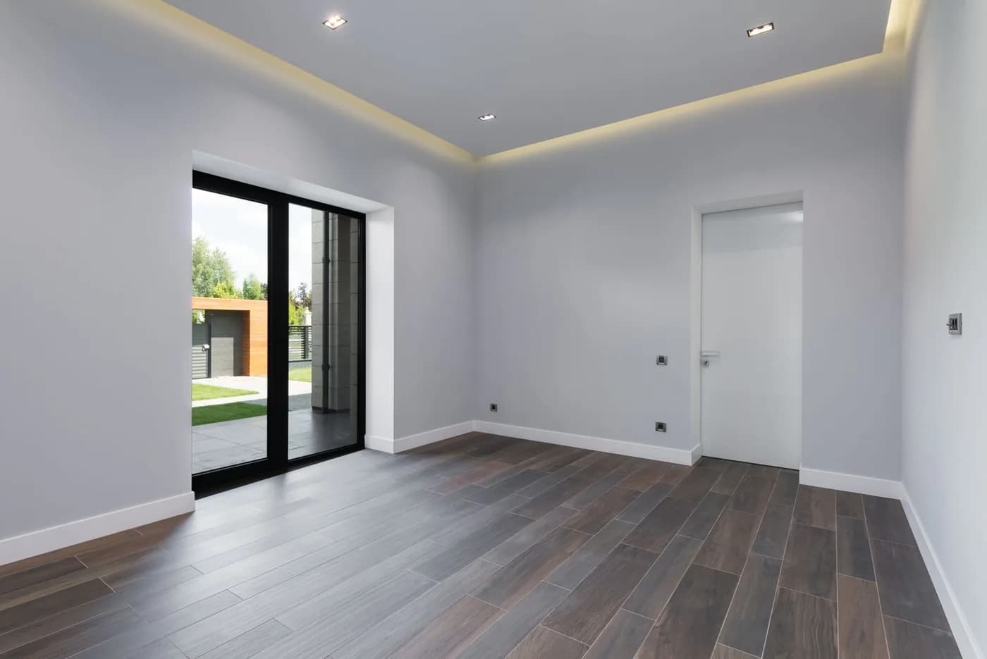 Dark-framed glazed patio doors opening towards a garden
